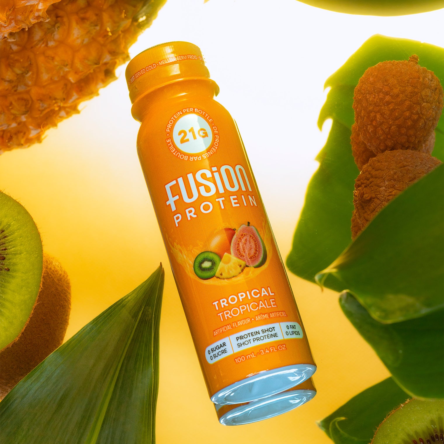 Fusion Protein Tropical shot bottle in water with fresh fruit